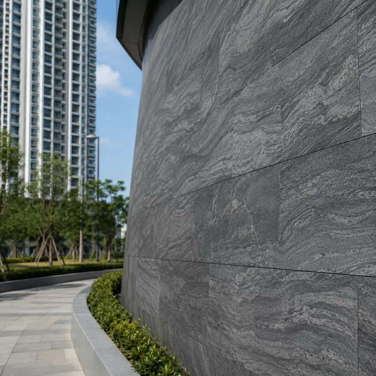 Flexible stone for high-rise safety and wind load benefits